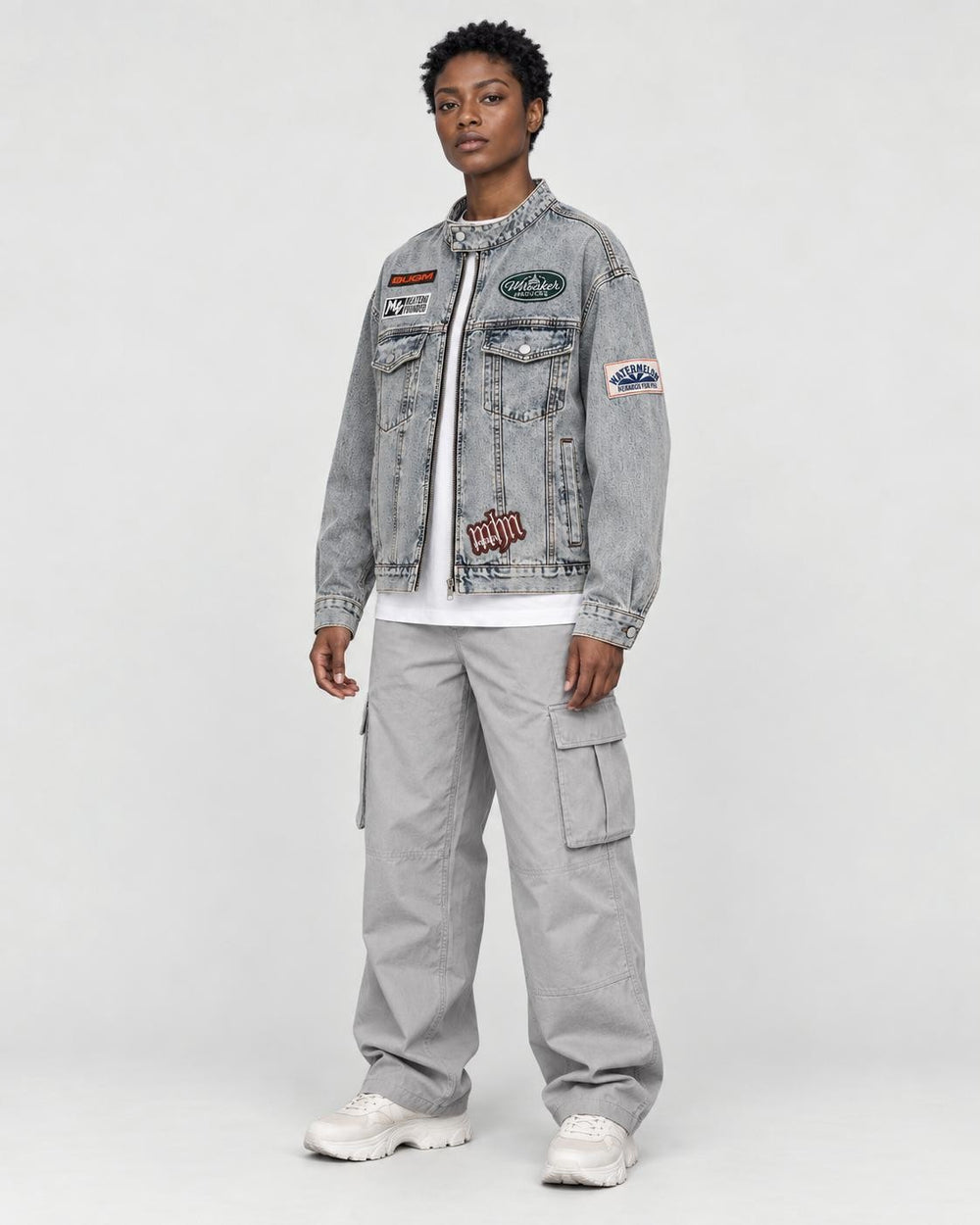 Model wearing the patch denim jacket, three-quarter view