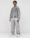 Model wearing the patch denim jacket, three-quarter view