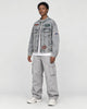 Model wearing the patch denim jacket, three-quarter view