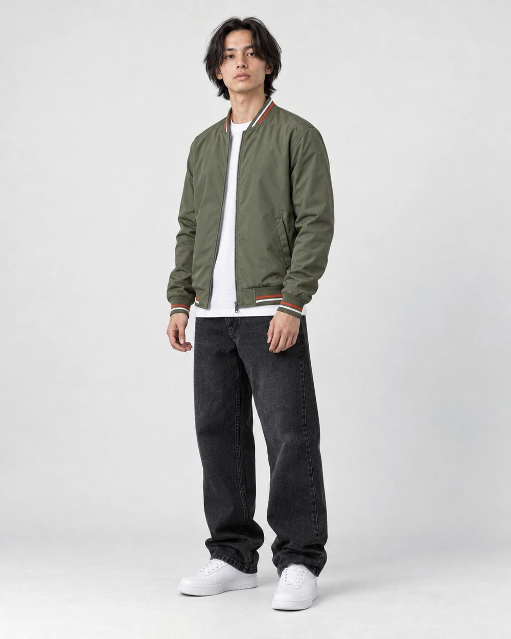 Model wearing the army green striped bomber jacket, three-quarter view