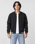 Model wearing the black striped bomber jacket over a white tee, front view