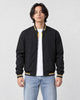 Model wearing the black striped bomber jacket over a white tee, front view