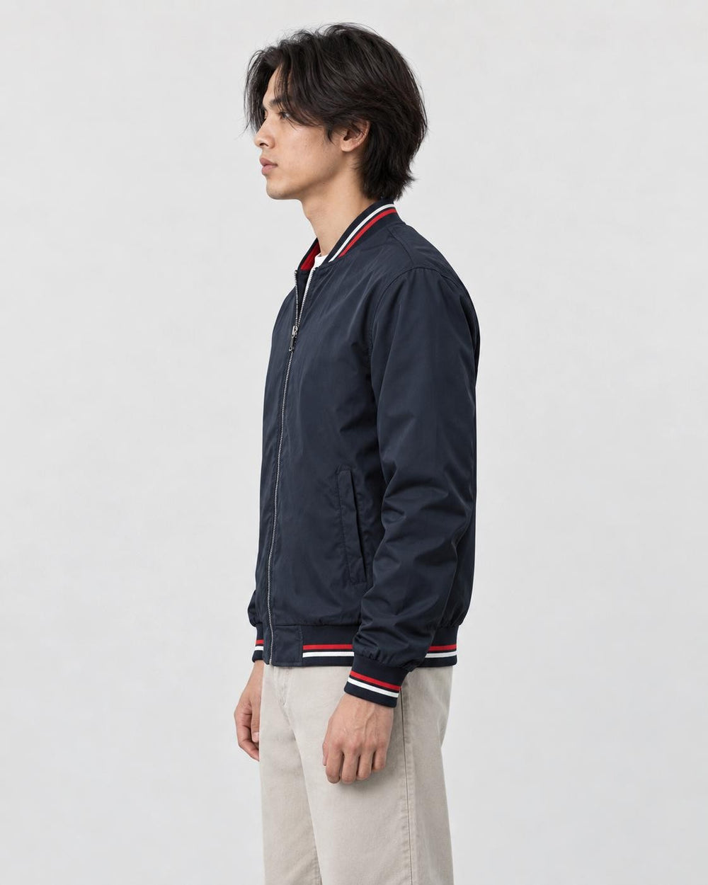 Model wearing the navy striped bomber jacket, side view