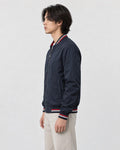 Model wearing the navy striped bomber jacket, side view