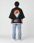 Full-length back view of a man in the black haori with an orange sun, a soaring bird and a winding river, with jeans