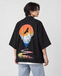 Man in the black haori seen from behind at an angle, with an orange sun and a soaring bird on the back, white tee
