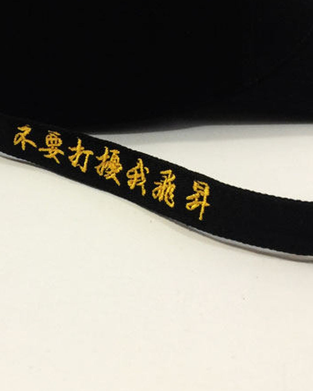 Close-up of the gold lettering along the long strap