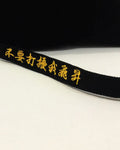 Close-up of the gold lettering along the long strap