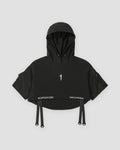 Black cropped hooded poncho top with ring straps at the hem, front view
