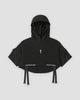 Black cropped hooded poncho top with ring straps at the hem, front view