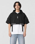 Model wearing the black cropped poncho top over a white tee, front view