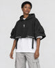 Model wearing the techwear poncho top with stone trousers, three-quarter view