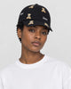 Model wearing the black teddy bear embroidered cap with a white tee, side view