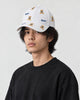 Model wearing the white teddy bear embroidered cap with a black tee, three-quarter view