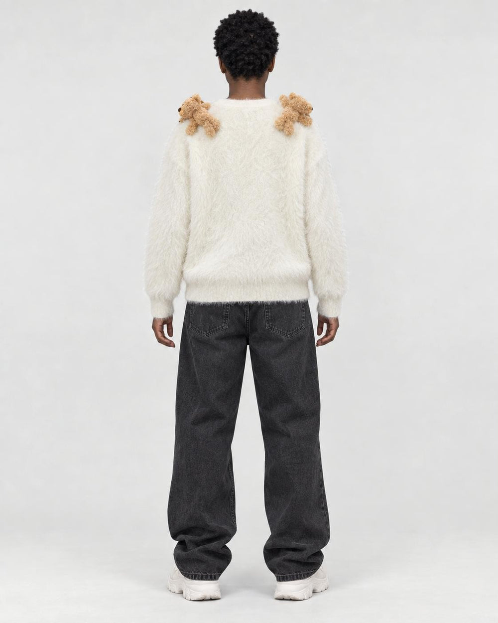 Model wearing the cream teddy bear sweater, back view