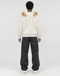 Model wearing the cream teddy bear sweater, back view