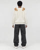 Model wearing the cream teddy bear sweater, back view