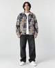 Model wearing the teddy bear jacquard overshirt open over a white tee, front view