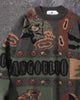 Close-up of the knitted teddy bear, acorns and lettering