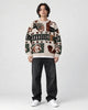 Model wearing the beige teddy bear patchwork sweater, front view