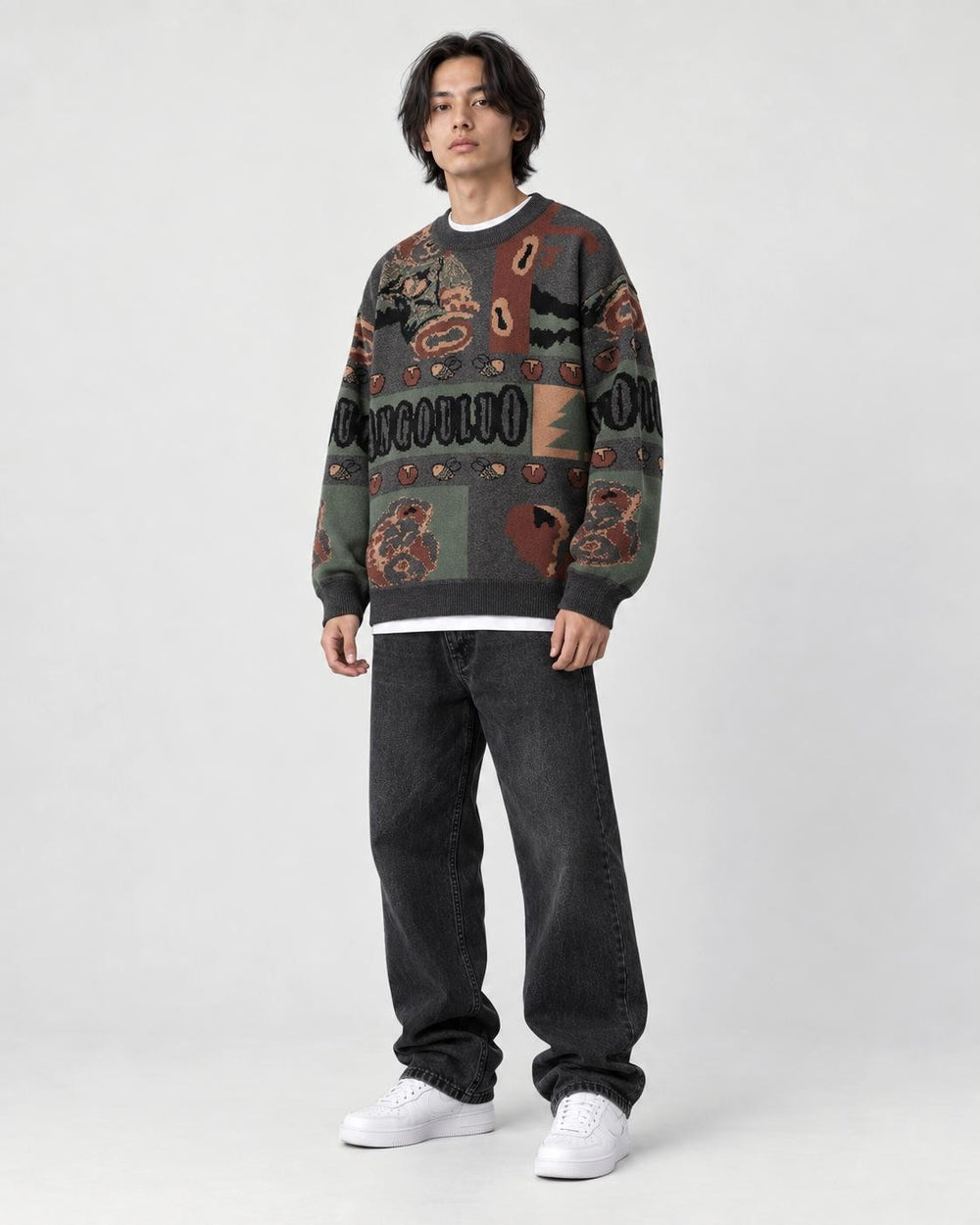 Model wearing the charcoal jacquard sweater, three-quarter view