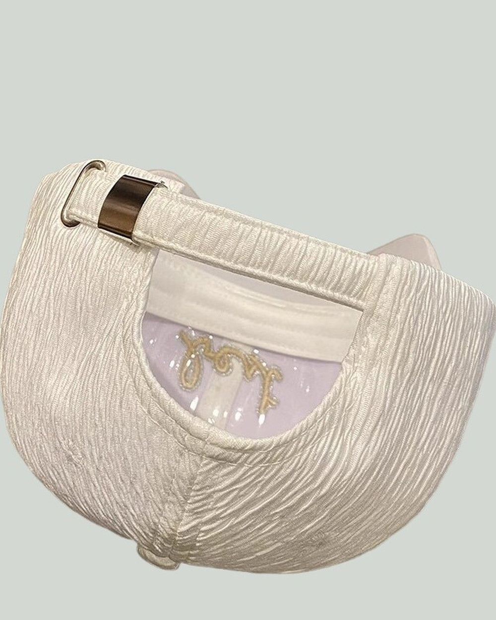 Rear view of the white textured cap showing the metal-slide strap adjuster and the inside of the crown