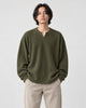 Model wearing the army green textured long sleeve tee with stone trousers, front view