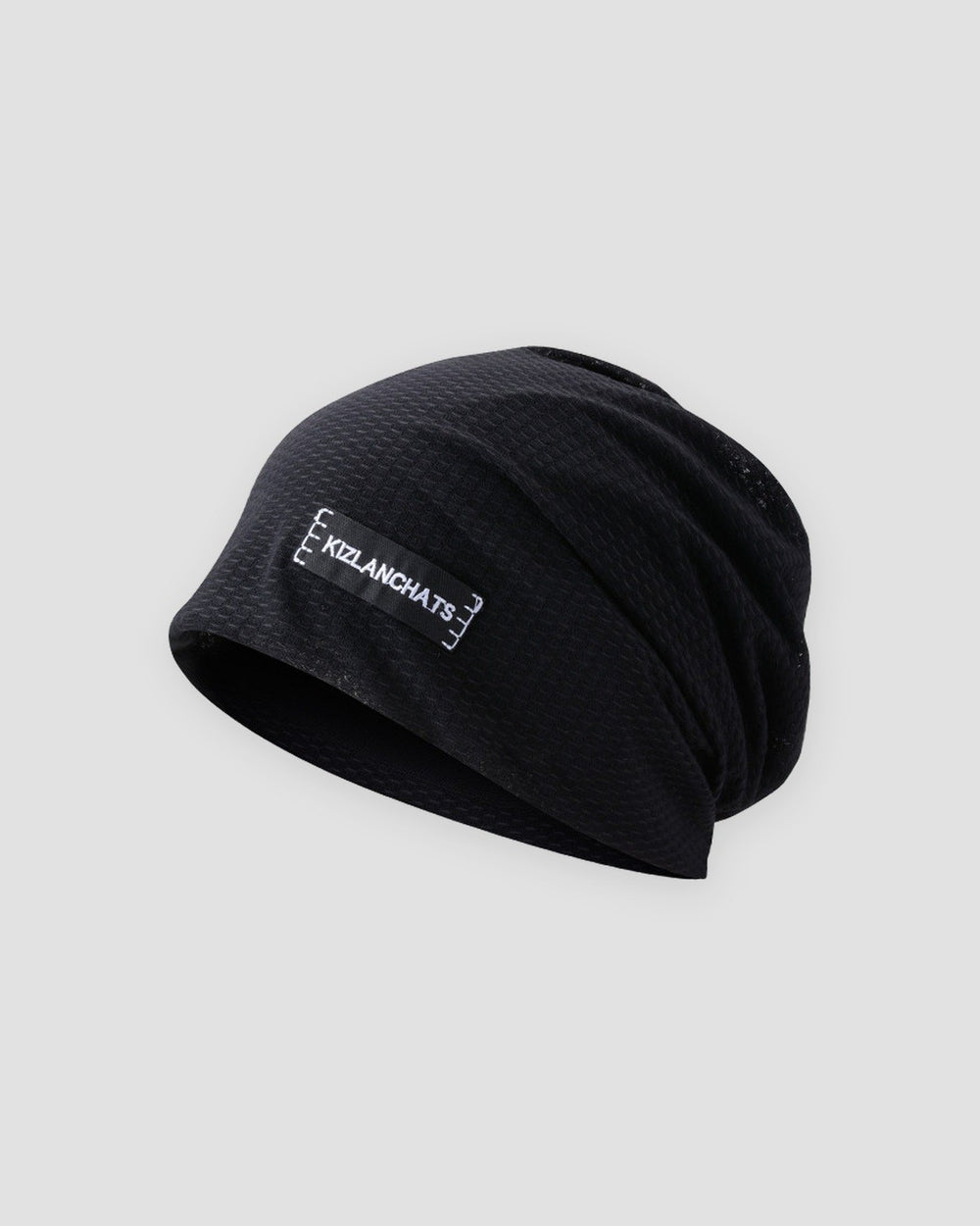 Black slouchy beanie in a thin honeycomb knit with a small black woven label