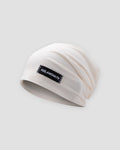 White slouchy beanie in a thin honeycomb knit with a small black woven label on the front