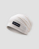 White slouchy beanie in a thin honeycomb knit with a small black woven label on the front