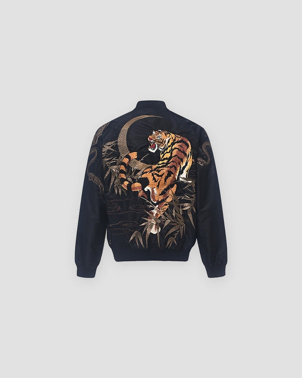 Back of the black bomber with a large embroidered tiger under a crescent moon among bamboo