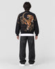 Model wearing the black tiger and dragon bomber jacket, back view of the tiger embroidery