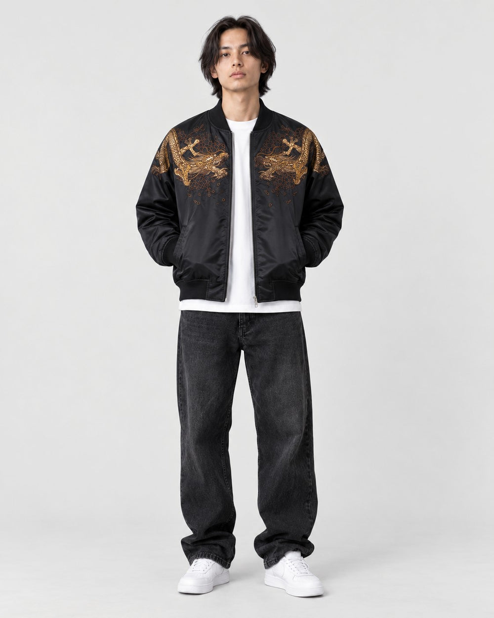 Model wearing the black tiger and dragon bomber jacket, front view with gold dragons on the chest