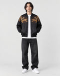 Model wearing the black tiger and dragon bomber jacket, front view with gold dragons on the chest