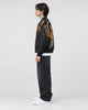 Model wearing the black tiger and dragon bomber jacket, side view