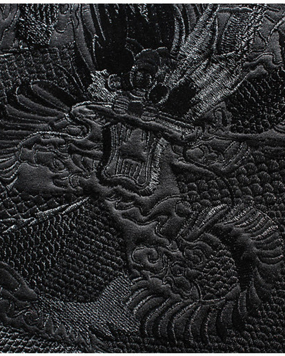Close-up of the black-on-black dragon embroidery
