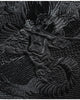 Close-up of the black-on-black dragon embroidery