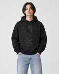 Model wearing the black dragon embroidered hoodie with light-wash jeans, front view