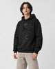Model wearing the black dragon embroidered hoodie with stone trousers, three-quarter view