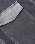 Close-up of the lighter-wash side pocket on the dark gray denim