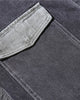 Close-up of the lighter-wash side pocket on the dark gray denim