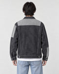 Model wearing the dark gray patchwork denim jacket, back view of the light yoke
