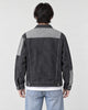 Model wearing the dark gray patchwork denim jacket, back view of the light yoke