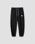 Black waffle knit joggers with a white drawcord and ribbed ankle cuffs, front view