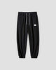 Black waffle knit joggers with a white drawcord and ribbed ankle cuffs, front view