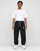 Model wearing the black waffle knit joggers with a white tee, front view