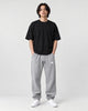 Model wearing the gray waffle knit joggers with a black tee, front view