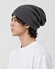 Model wearing the dark gray slouchy beanie, side view showing the slouch