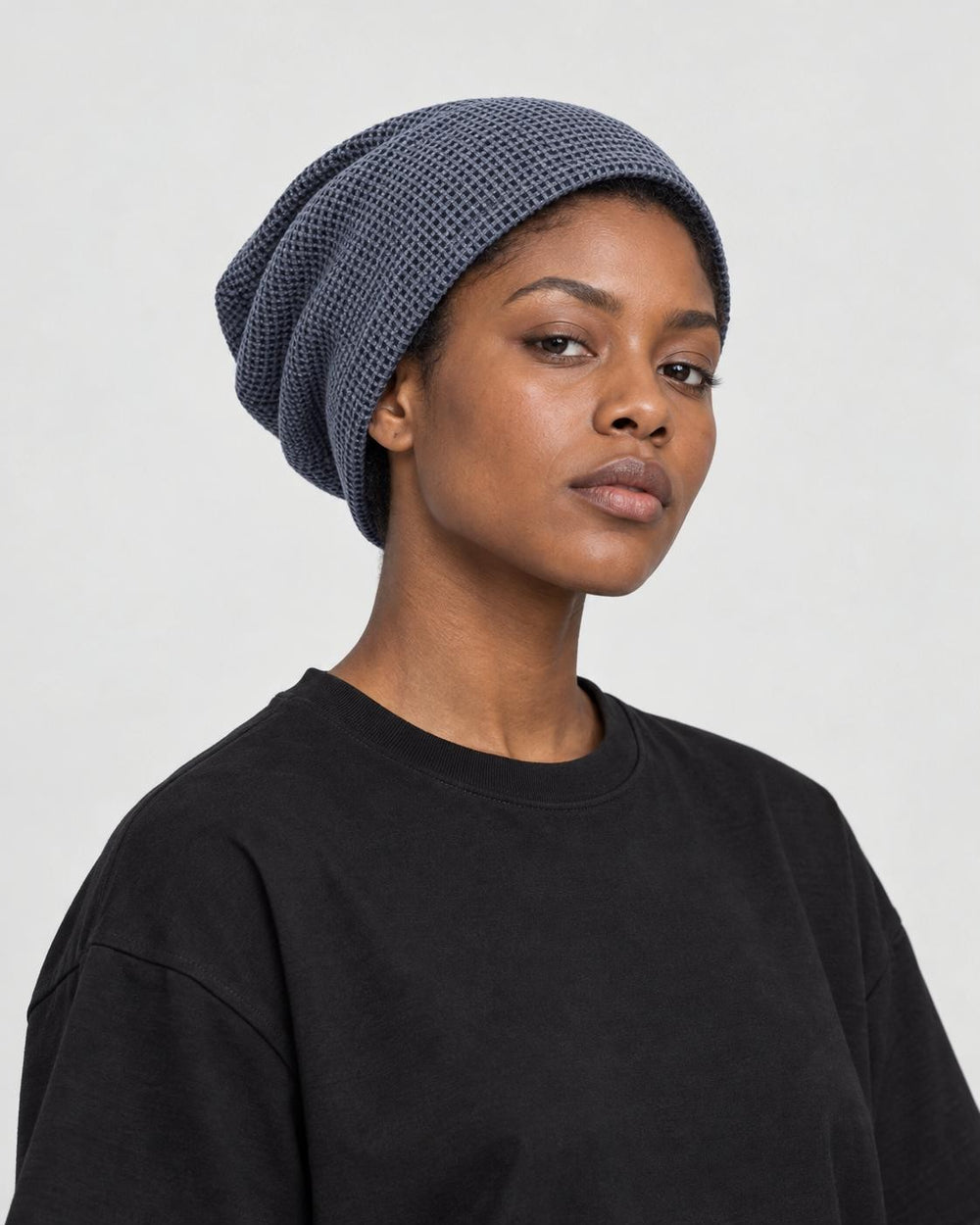 Model wearing the blue gray waffle knit beanie, three-quarter view