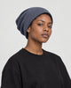 Model wearing the blue gray waffle knit beanie, three-quarter view